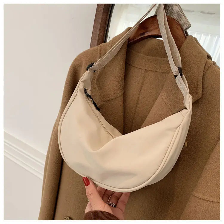 Women's bag - A round-shaped nylon bag with a cross-body strap, suitable for traveling, going to school or shopping.
